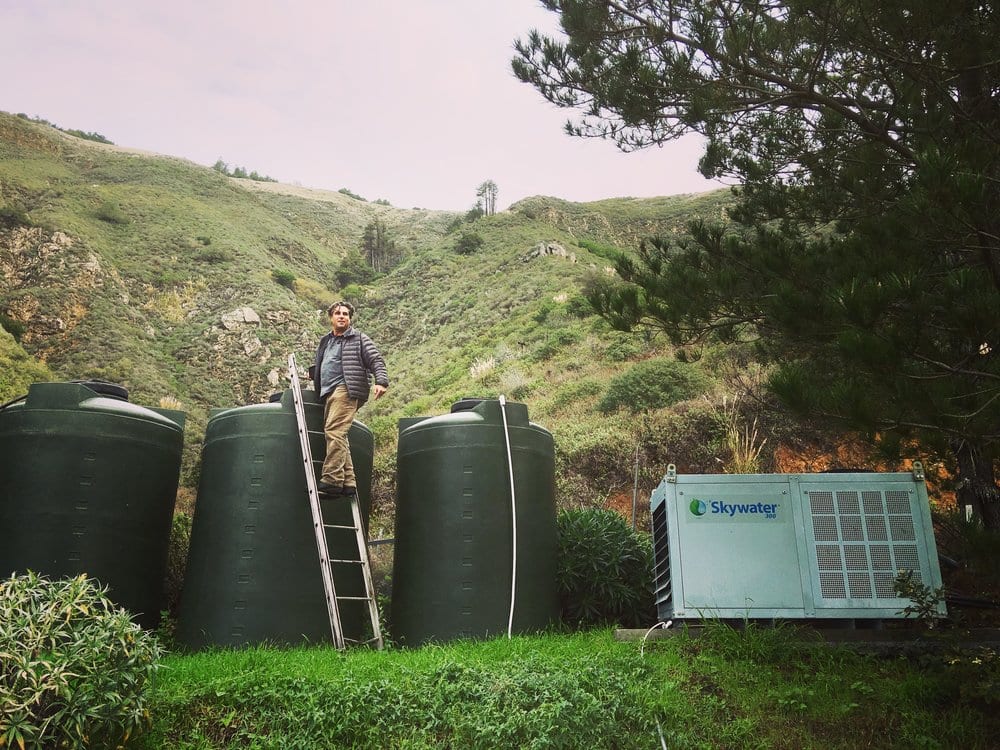 David Hertz harvesting water in Big Sur, California. Skywater 150 produces up to 150 gallons a day, and the water can be stored in water collection tanks for future use.  PHOTO CREDIT SKYSOURCE